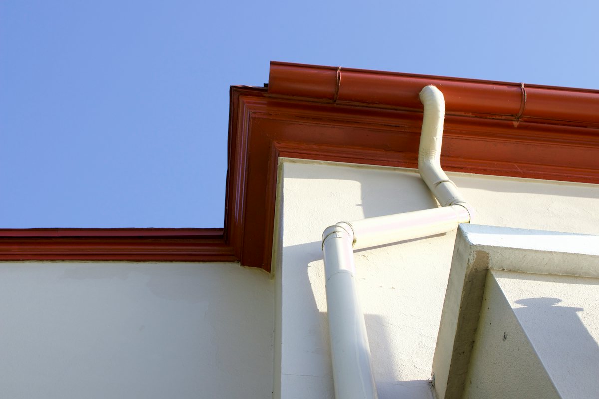 Metal rain gutter running along the edge of a roof