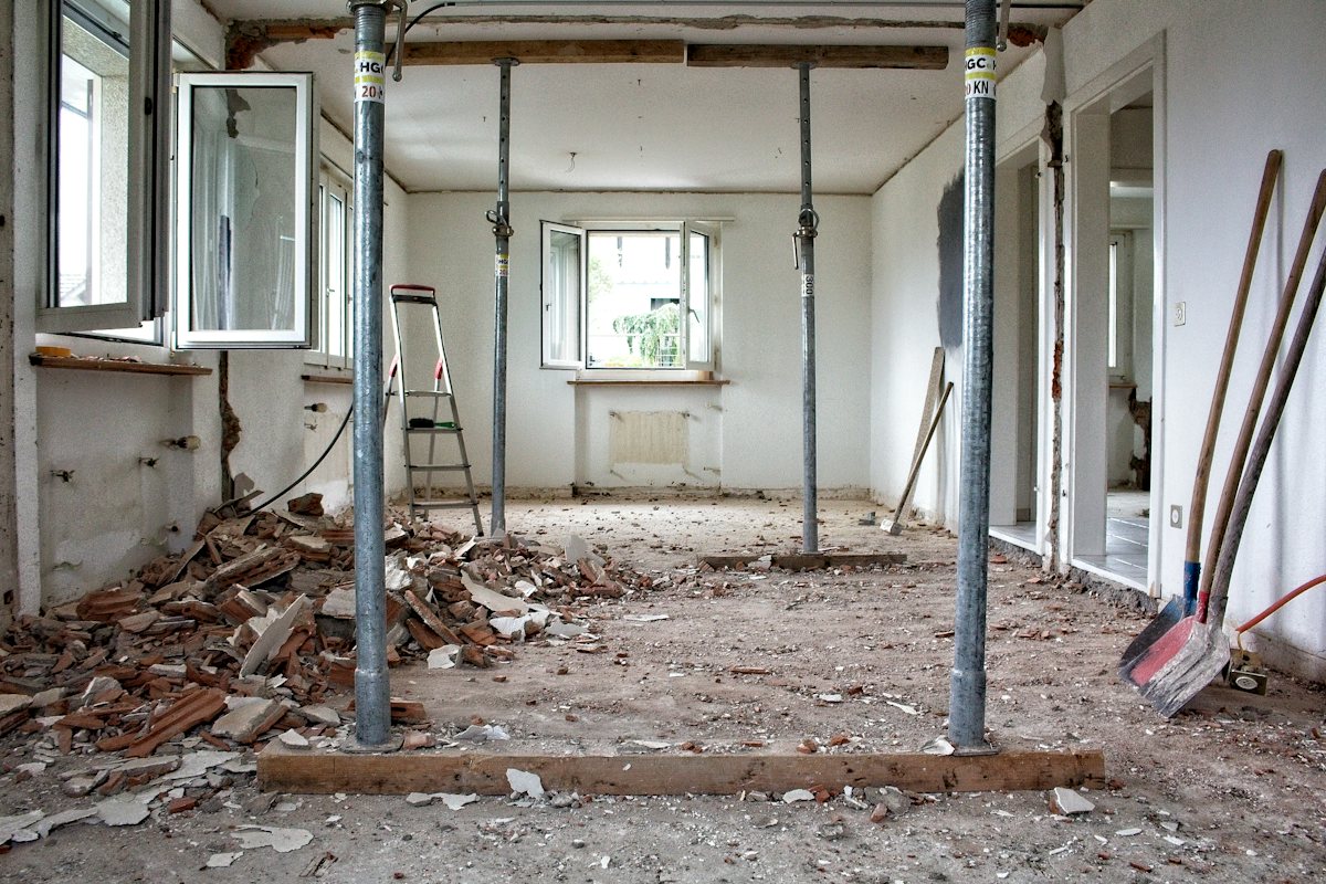 Room under renovation with metal support poles holding up the ceiling