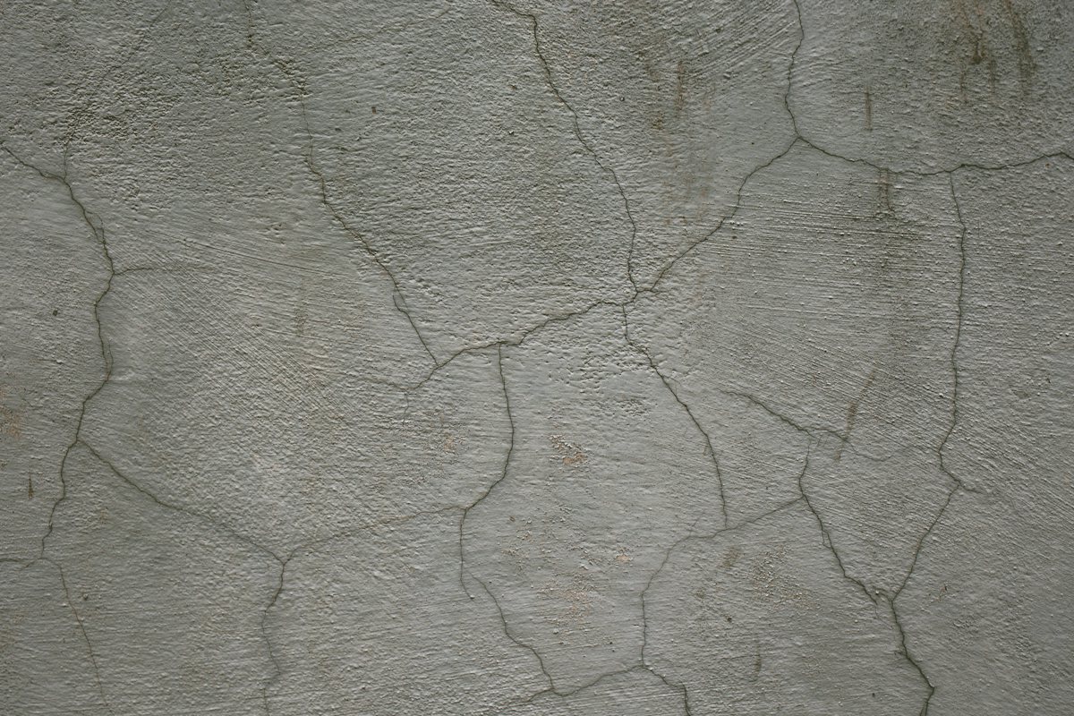 Dark concrete wall with a long, branching crack